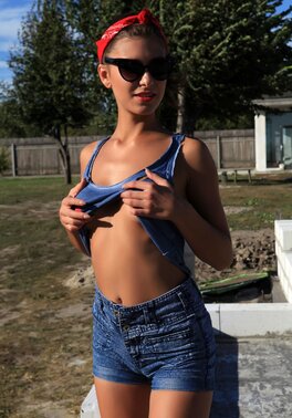Willowy model disrobes flawless tanned body and poses in the sunrays