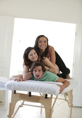 Latin girl massages naked client under control of handsome instructor