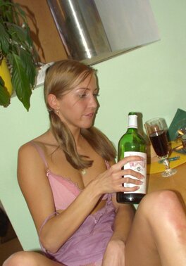 Tight pussy gets wet as its owner drinks alcohol and starts stripping by table
