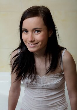 Girl washes soapy body and masturbates shaved pussy using dildo in bathroom
