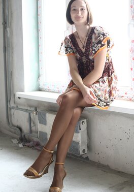 Girl poses in dress and then takes it off opening her shaved snatch on windowsill