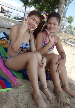 Thai babes rest on a beach and pose in tight bikini flashing innie navels