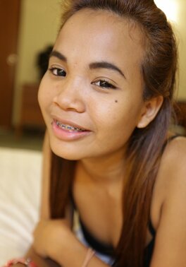 Teen Asian girl looks very cute despite the fact that she wears braces