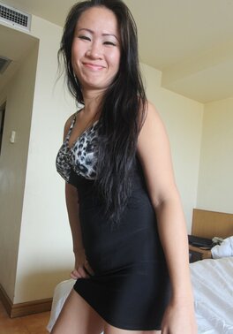 Good-looking Asian female carefully gets naked and touches her shaved pussy