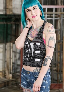 Babe with blue hair in striped stockings has a tattooed body to expose on a bench