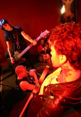 Girl is living it up at a rock concert and as singer comes closer she kisses him