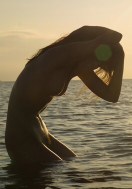 Svelte cutie with small tits and long legs poses absolutely naked on empty beach