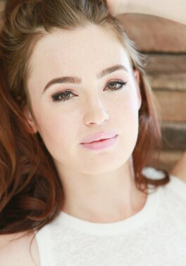Photographer takes pics of the red-haired girl's face before she undresses