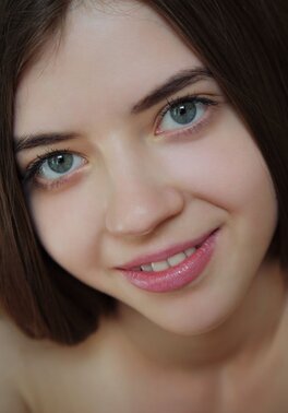 Babe gets naked and spreads legs to demonstrate her sweet young vagina