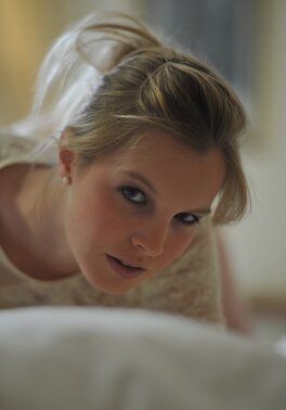Adorable blonde lassie in lingerie exposes perky assets in various erotic poses