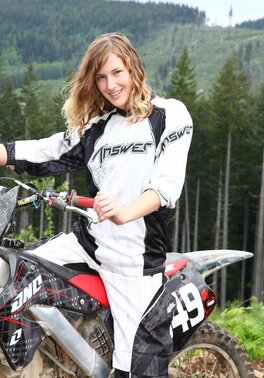 Slutty teen tomboy rides the motorcycle and poses by the car all naked