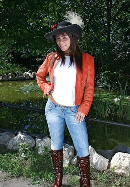 Young girl in boots undresses to flaunt her tempting naked body outdoors