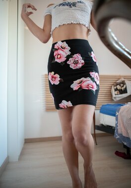 Short hair babe is showing her small boobs and long legs