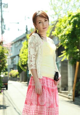 Asian beauty with red hair seductively walks on sunny street of big city