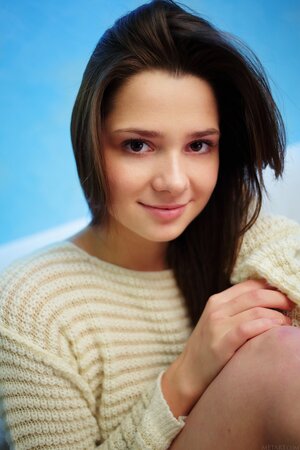 Attractive chick with naked pussy takes off sweater and poses in warm socks