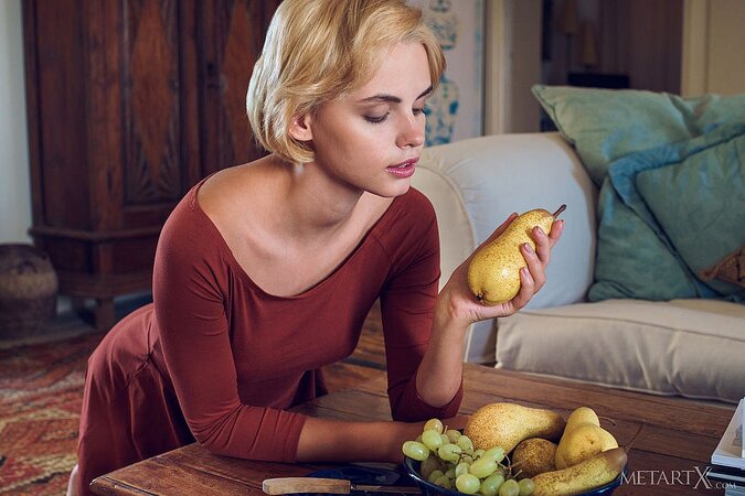 Blonde with aristocratic body shapes takes off elegant dress and poses on table