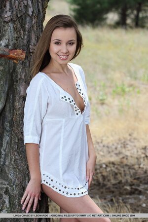Natural teen comes to spacious forest to walk naked and with no onlookers around