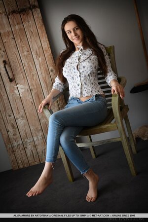 Beautiful brown-eyed teen takes off shirt and jeans at the photo session