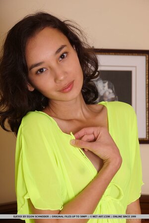 Small-tittied exotic teen in a bright-green robe flaunts flat chest and hairy muff