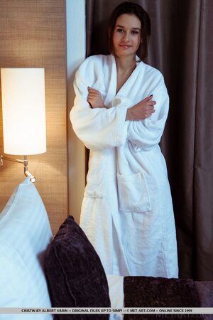 Babe enters bedroom after bathing and takes off white robe showing slender body