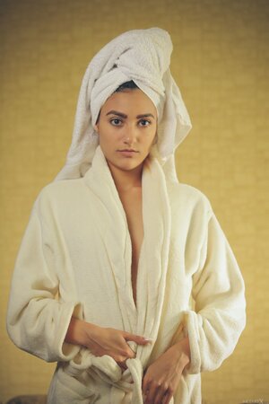 Whore with a towel on head and in white robe gives sexual pleasure to pussy