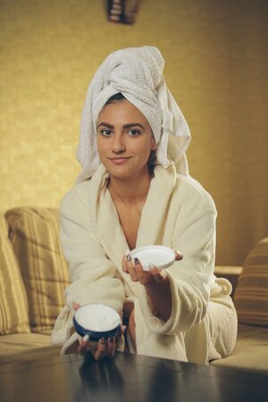 Dark-haired teen gets rid oа the towel and robe and relaxes after bathing time