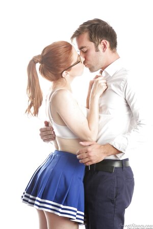 Funny red-haired high-school cheerleader Penny Pax strips while dancing