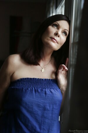 Black-haired mature strips near window while waiting for arrival of her lover