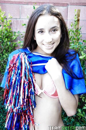 Slender cutie takes off cheerleader outfit and shows perky tits in fresh air