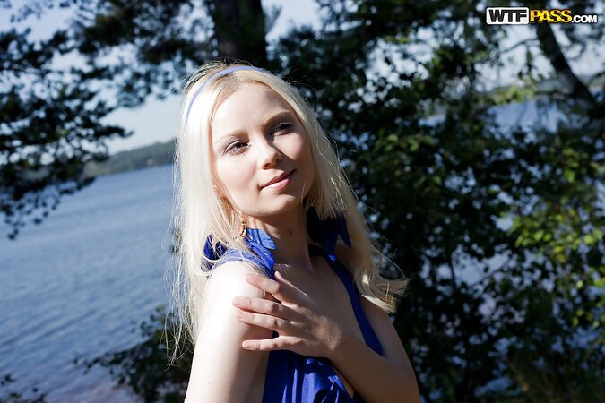 Blonde young lovely in blue headband treats pussy with fingers outdoors