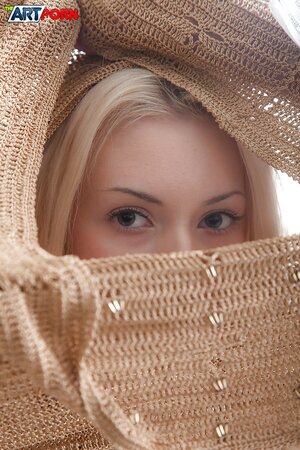 Entrancing blonde with pale skin has something to show in naked solo pics