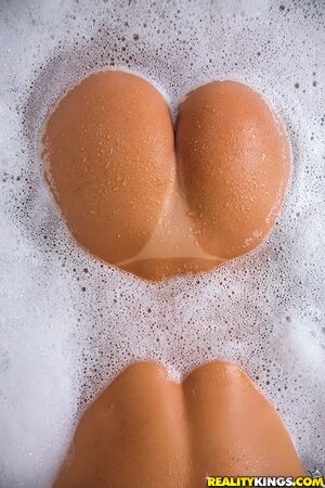 Pretty babe in a white shirt goes to the bathroom to wash her sexy buttocks