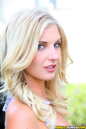 Attractive blonde Natalie Nice takes off dress to show her assets in garden