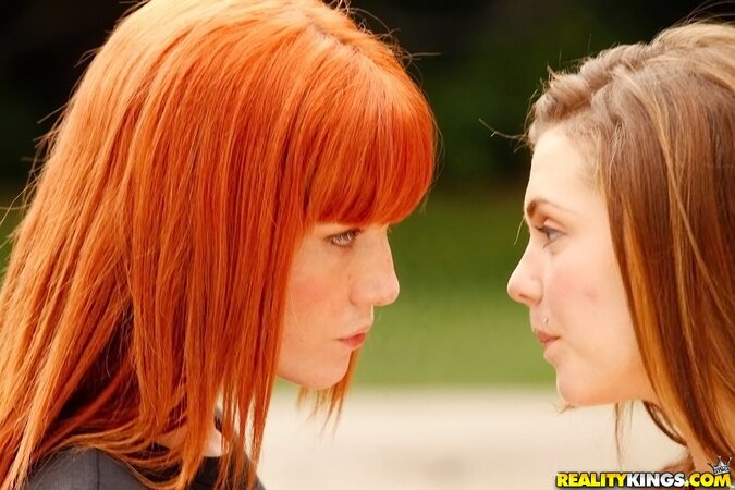 Innocent girlfriends meet outdoors to have naked foreplay in park