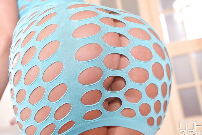 Sensual girl in a fishnet blue dress takes it off and starts anal self-sex
