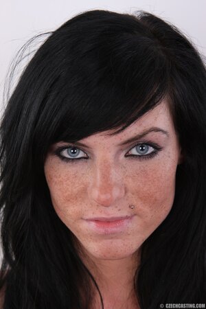 Brunette babe with bright eyes and pierced upper lip is sexy and she knows it
