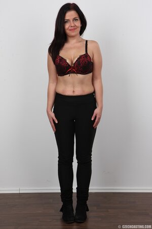 Black-haired woman takes clothes off to show saggy tits and small ass