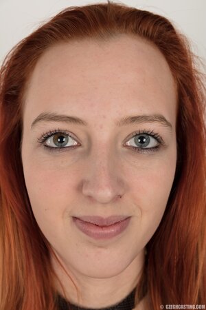 Pale chick with red hair unveils small breasts but doesn't take black panties off