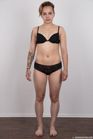 Young woman with small nice boobies and boyish figure doesn't shy to get naked