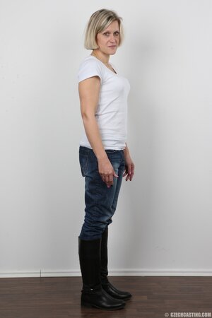 Blonde mature woman in jeans and white lingerie doesn't protect her privacy