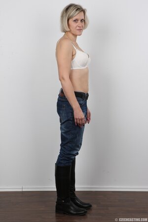 Blonde mature woman in jeans and white lingerie doesn't protect her privacy