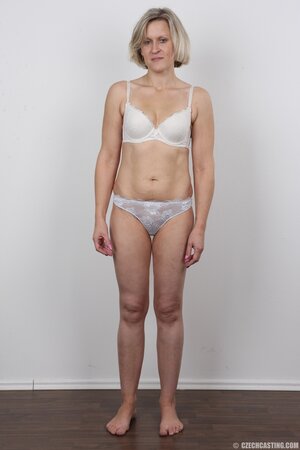 Blonde mature woman in jeans and white lingerie doesn't protect her privacy