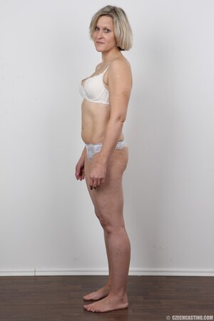 Blonde mature woman in jeans and white lingerie doesn't protect her privacy
