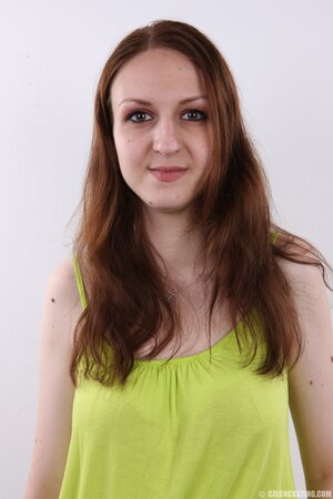 Amateur girl wears green top and blue jeans but finally takes all off