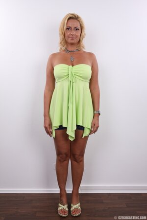 Slut in a green dress is so lecherous that she takes it off stripping naked