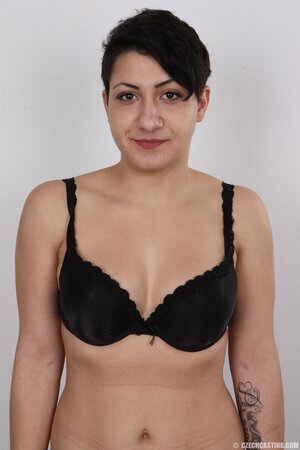 Slutty female in black bury shyness and comes to a porn studio to pose in the nude
