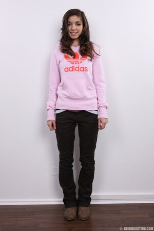 Model takes sweatshirt and striped tunic off continuing with bra and panties
