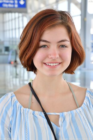 Suggestive teen with red hair presents natural titties and trimmed twat