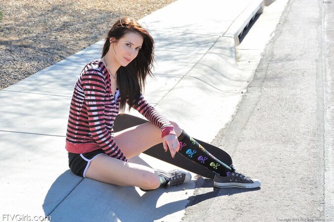 Hot skateboarder demonstrates sexy long legs and small boobs in the city
