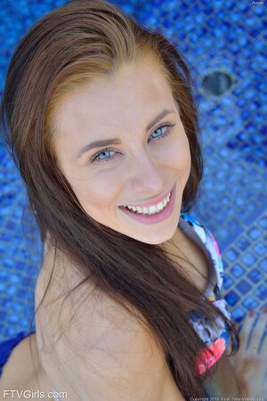 Inviting love with bright eyes rests by the pool with ribbed dildo in her fanny